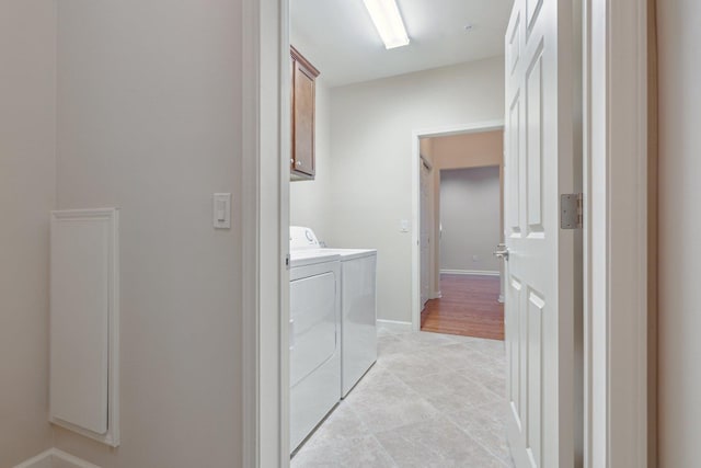 laundry area featuring cabinets and washing machine and clothes dryer