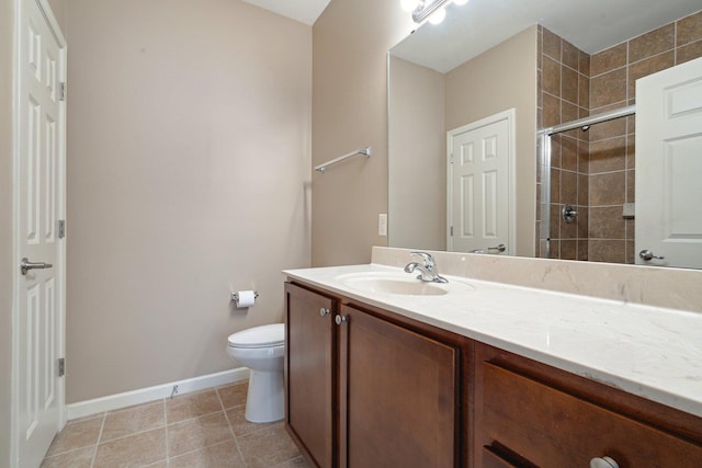 bathroom with tile patterned flooring, vanity, toilet, and a shower with shower door