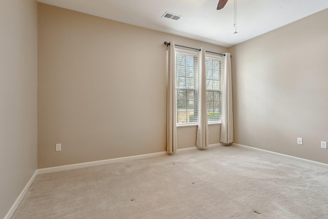 carpeted spare room with ceiling fan