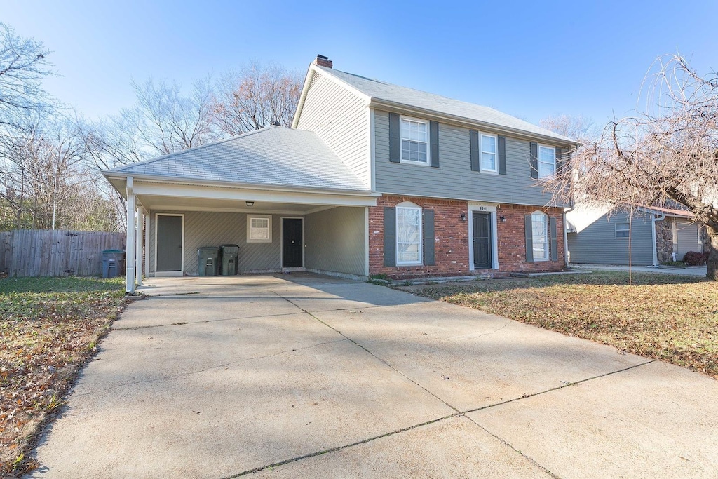 view of front of property with a front yard and a carport