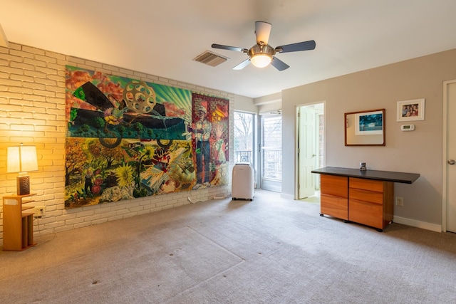 living room with ceiling fan, light carpet, and brick wall