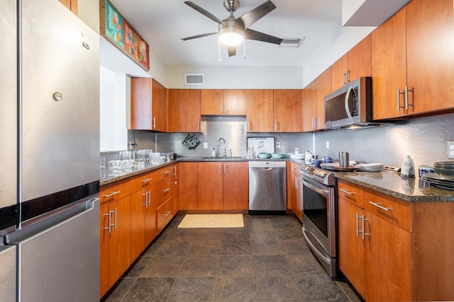 kitchen featuring backsplash, stainless steel appliances, ceiling fan, and sink