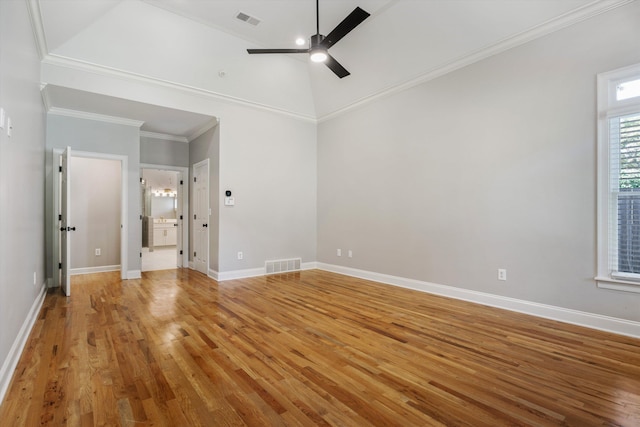 empty room featuring ceiling fan, crown molding, high vaulted ceiling, and hardwood / wood-style flooring