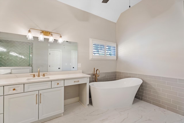 bathroom featuring a bathing tub, ceiling fan, vanity, and lofted ceiling