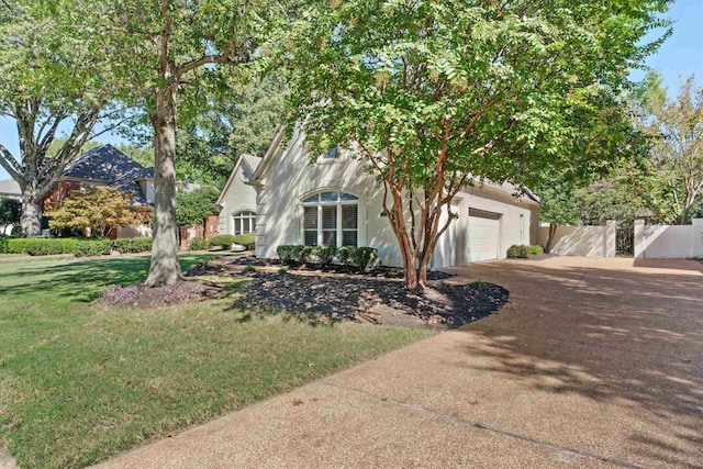 view of front of house featuring a front yard and a garage