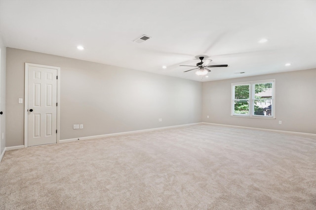 carpeted empty room featuring ceiling fan