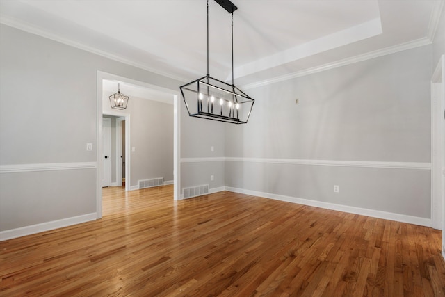 unfurnished dining area with crown molding and hardwood / wood-style floors