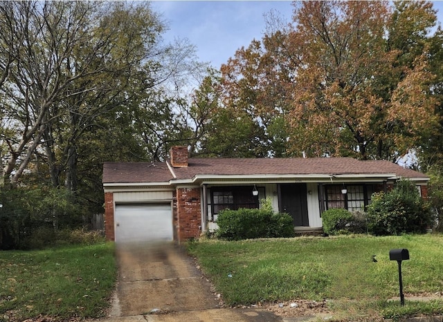 view of front of property featuring a garage and a front lawn