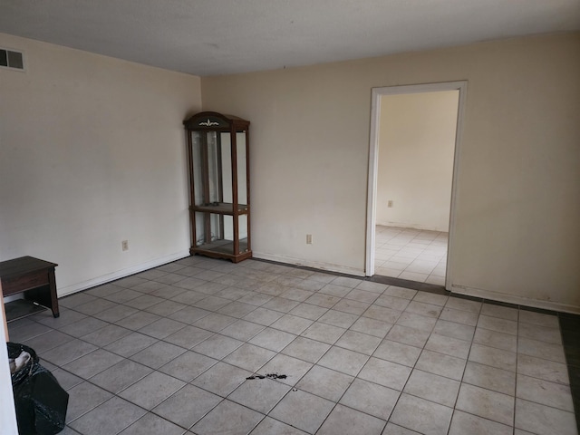 unfurnished room with light tile patterned floors