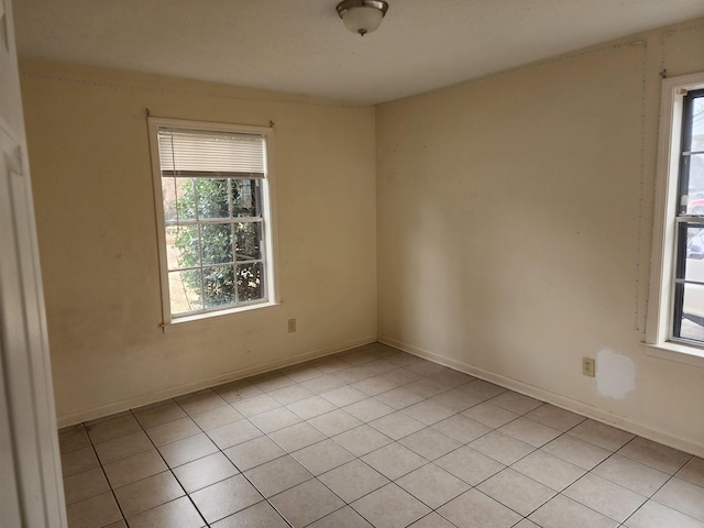 tiled spare room featuring a wealth of natural light