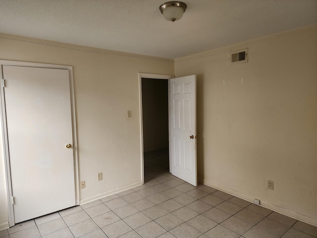 unfurnished bedroom featuring light tile patterned floors