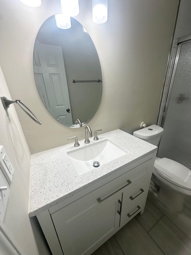 bathroom with tile patterned floors, vanity, and toilet