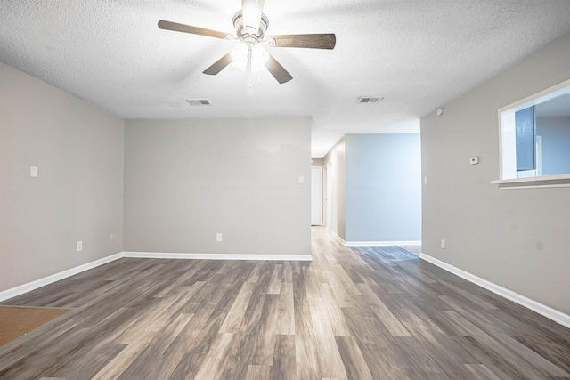 unfurnished room featuring a textured ceiling, ceiling fan, and dark hardwood / wood-style floors