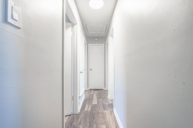 corridor with hardwood / wood-style flooring