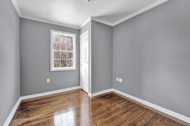 empty room featuring dark hardwood / wood-style floors and ornamental molding