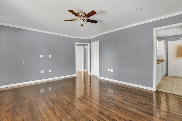 empty room with ceiling fan, crown molding, and dark wood-type flooring