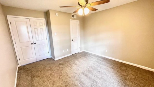 unfurnished bedroom featuring carpet floors, a closet, and ceiling fan