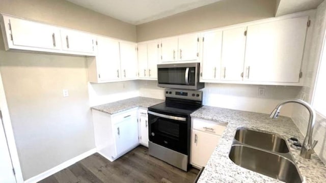 kitchen featuring white cabinets, light stone countertops, sink, and appliances with stainless steel finishes