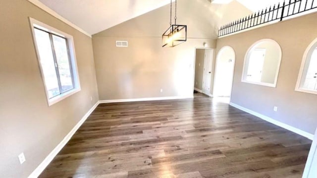 unfurnished dining area with dark hardwood / wood-style flooring and high vaulted ceiling