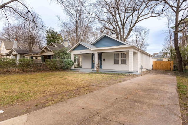 view of front of home with covered porch and a front yard