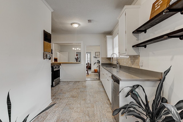 kitchen with white cabinetry, stainless steel gas stove, sink, backsplash, and a textured ceiling