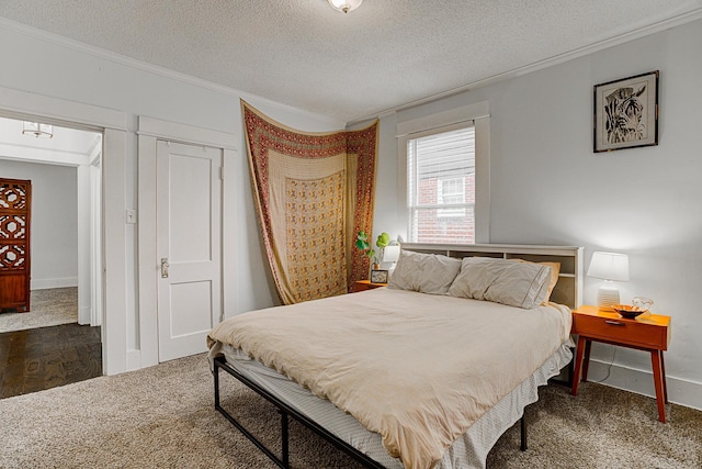 carpeted bedroom featuring a textured ceiling and crown molding