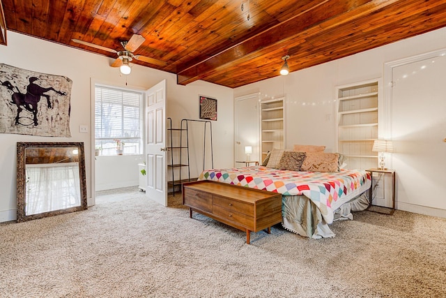 bedroom with carpet, ceiling fan, beam ceiling, and wood ceiling