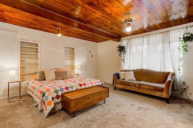 carpeted bedroom featuring beamed ceiling, ceiling fan, and wood ceiling