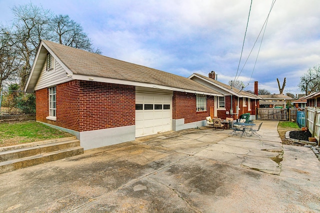 view of side of home with a patio and a garage