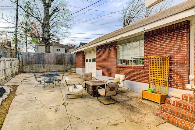 view of patio with a fire pit and a garage