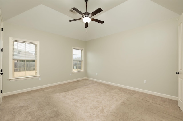 carpeted spare room with ceiling fan and lofted ceiling