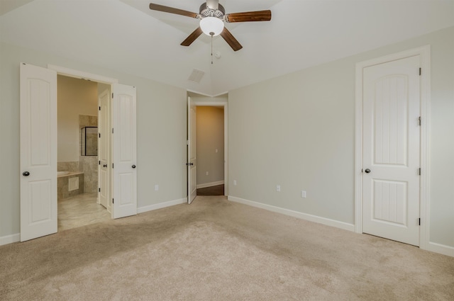 unfurnished bedroom featuring connected bathroom, light colored carpet, and ceiling fan