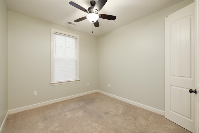 spare room with light carpet and ceiling fan