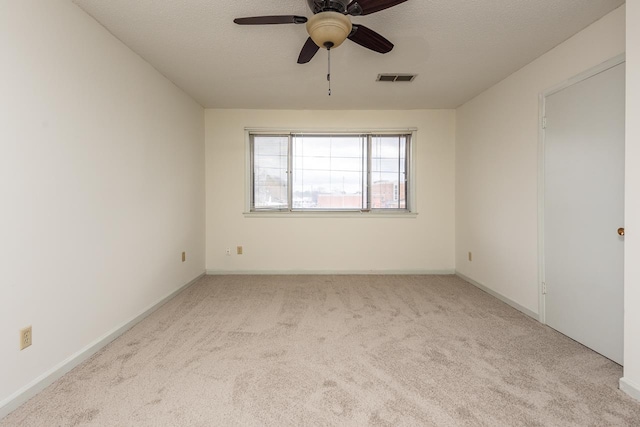 spare room featuring ceiling fan and light colored carpet