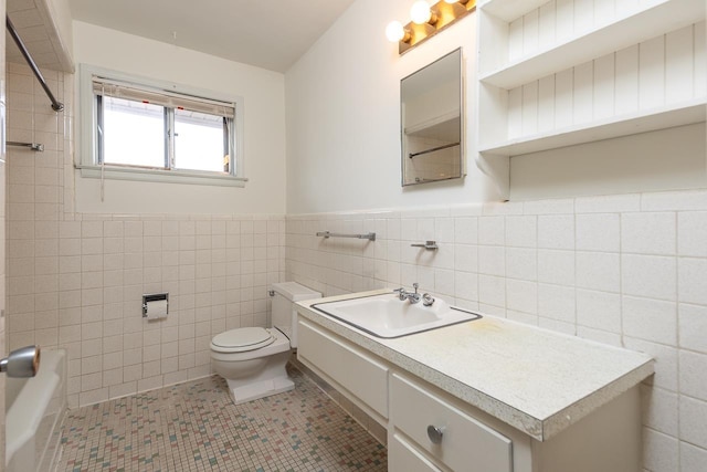 bathroom with tile patterned flooring, vanity, toilet, and tile walls