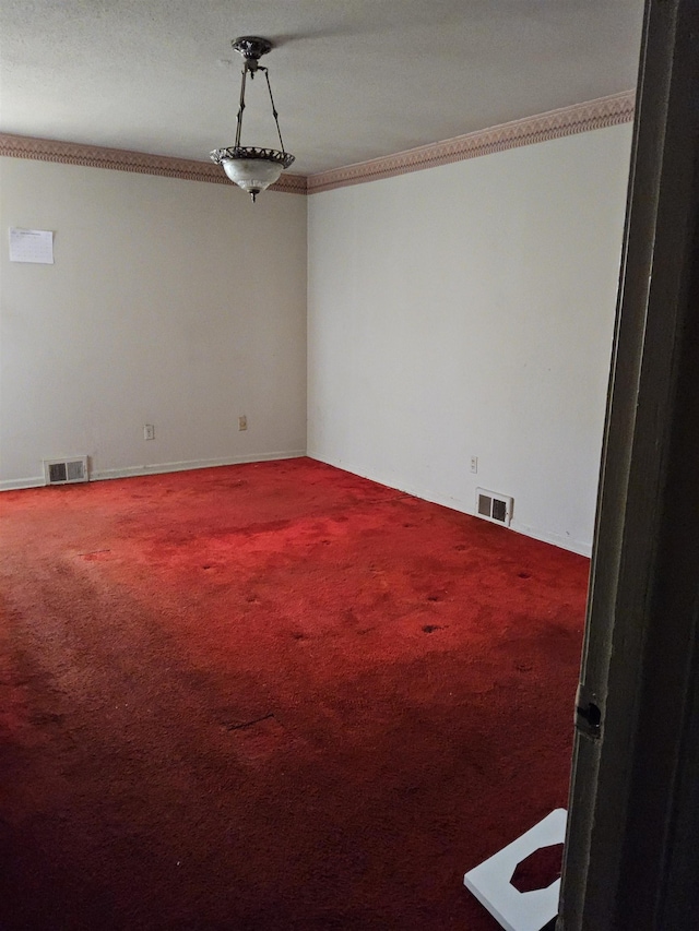 unfurnished room with carpet floors and crown molding