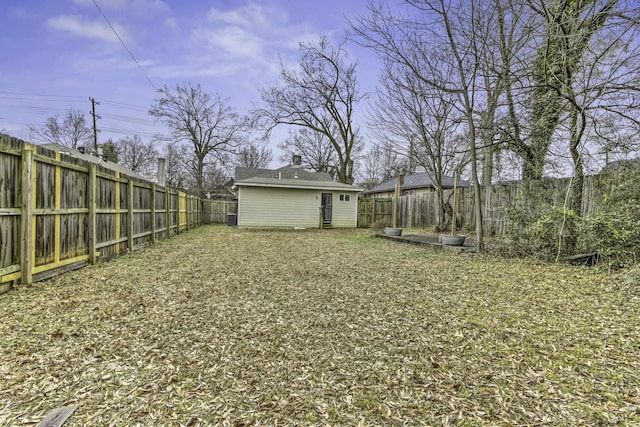 view of yard with an outbuilding and a fenced backyard