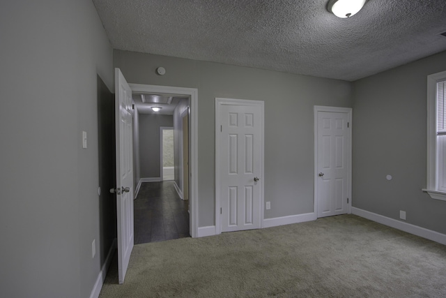 unfurnished bedroom with carpet floors and a textured ceiling