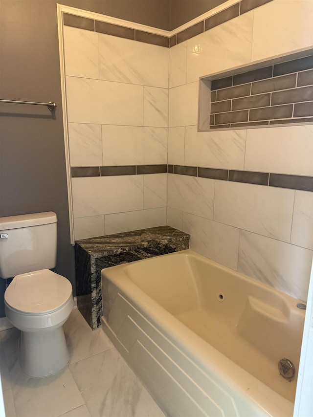 bathroom featuring a washtub and toilet