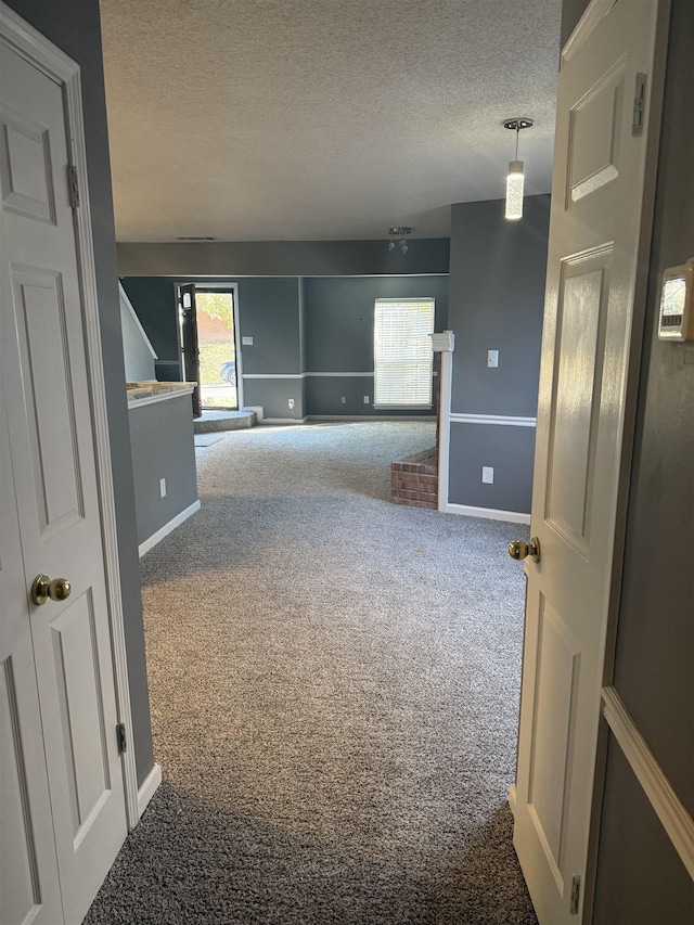 carpeted spare room featuring a textured ceiling