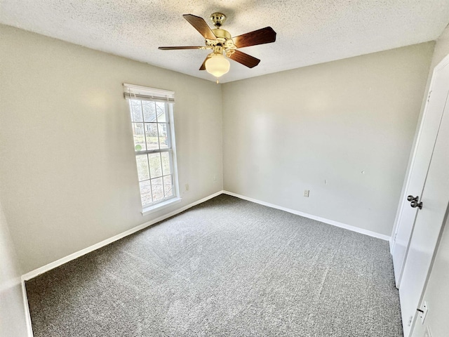 carpeted spare room with ceiling fan and a textured ceiling