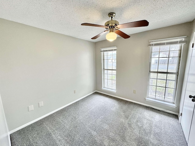 unfurnished room with carpet flooring, ceiling fan, plenty of natural light, and a textured ceiling