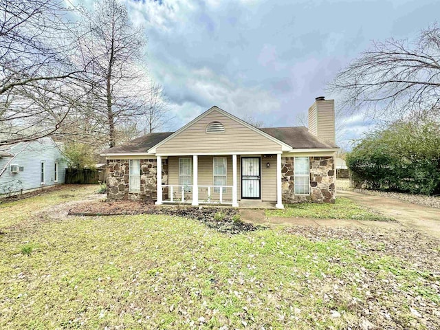 view of front of property with covered porch and a front yard