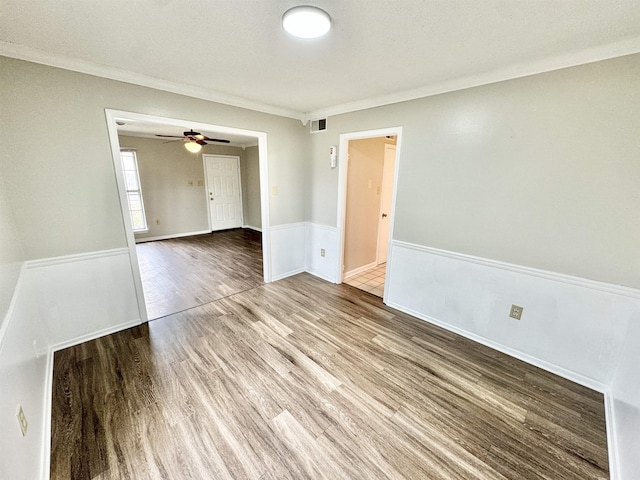 unfurnished room with crown molding and hardwood / wood-style floors