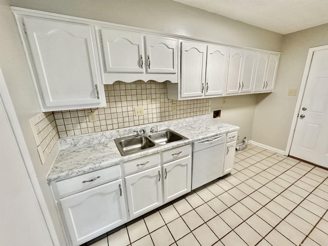 kitchen with white cabinetry, dishwasher, light tile patterned floors, and sink