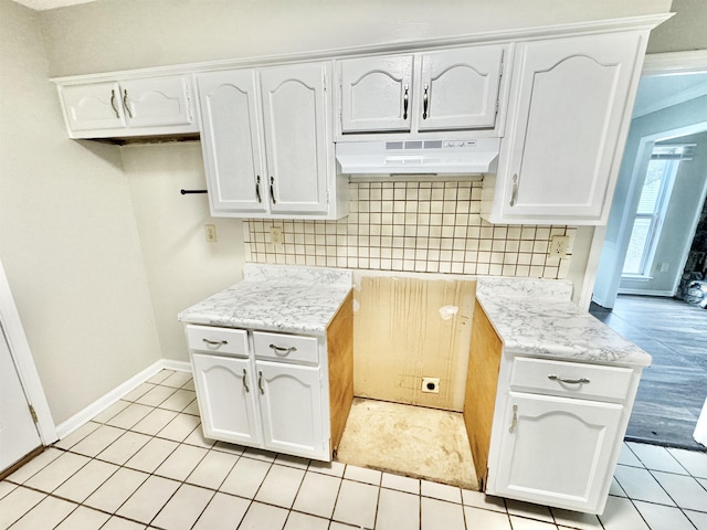 kitchen featuring white cabinetry and light tile patterned floors