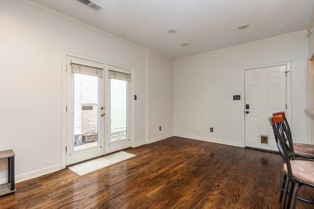 interior space featuring a healthy amount of sunlight, dark wood-type flooring, and ornamental molding