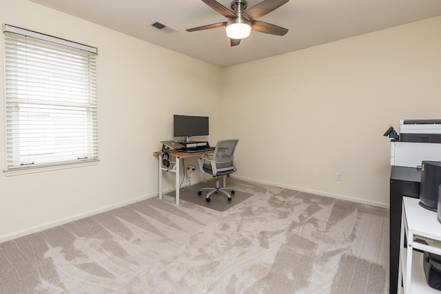 carpeted office featuring ceiling fan