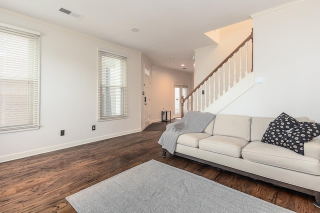 living room with dark wood-type flooring and ornamental molding