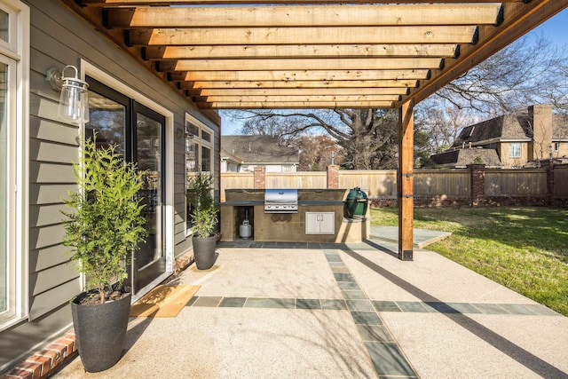 view of patio / terrace with area for grilling and a pergola